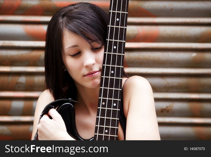 Young beautiful guitarist holding lovely her instrument. Young beautiful guitarist holding lovely her instrument.