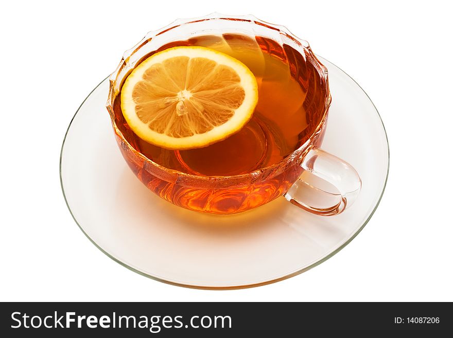 Glass cup with tea and a lemon on a white background
