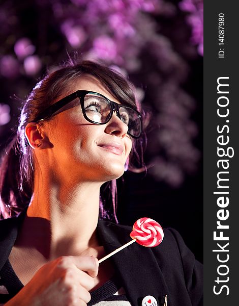 Lovely girl wearing glasses and holding a lollipop. Lovely girl wearing glasses and holding a lollipop