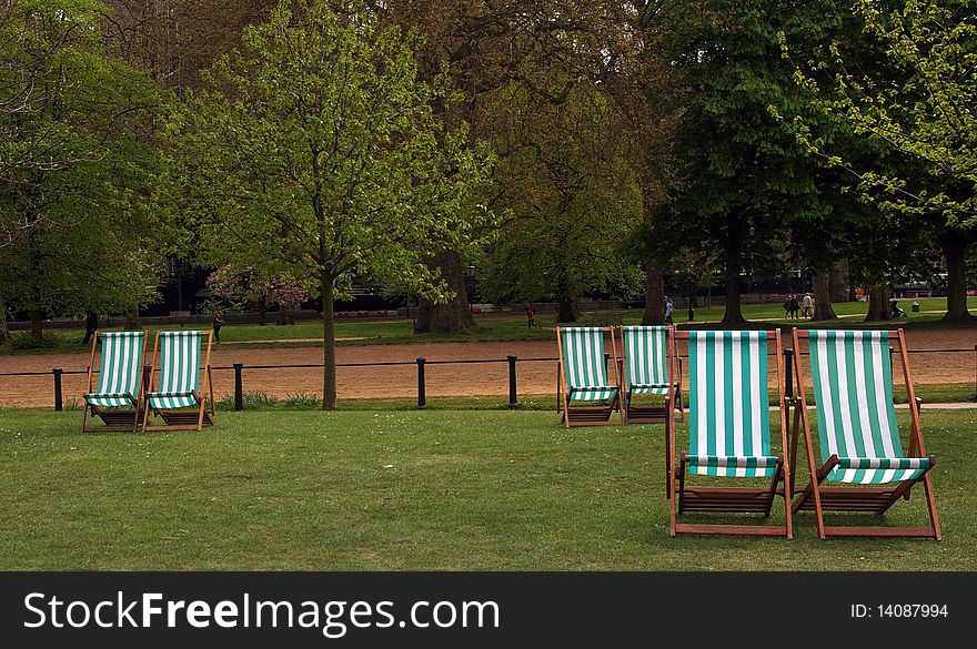 Six deckchairs in Hyde Park, London, England. Six deckchairs in Hyde Park, London, England.