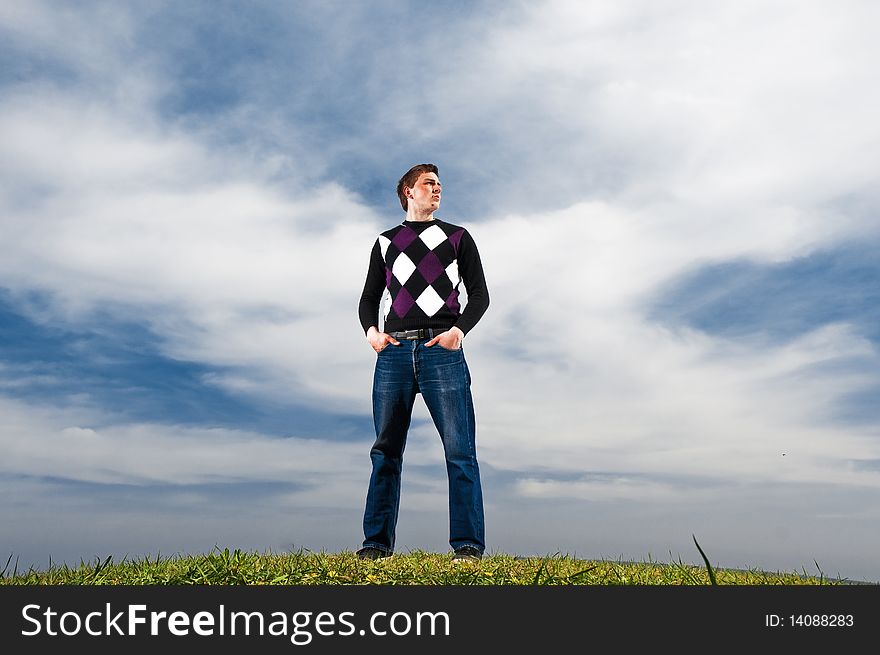 Young Man In The Clouds On The Green Grass