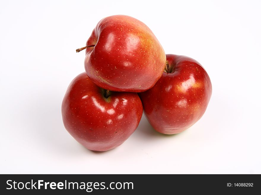 Three red apples on white background