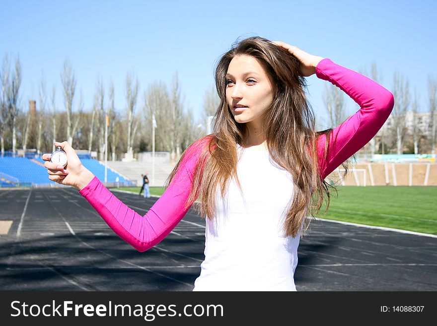 Young woman at the sport competition with stopwatch