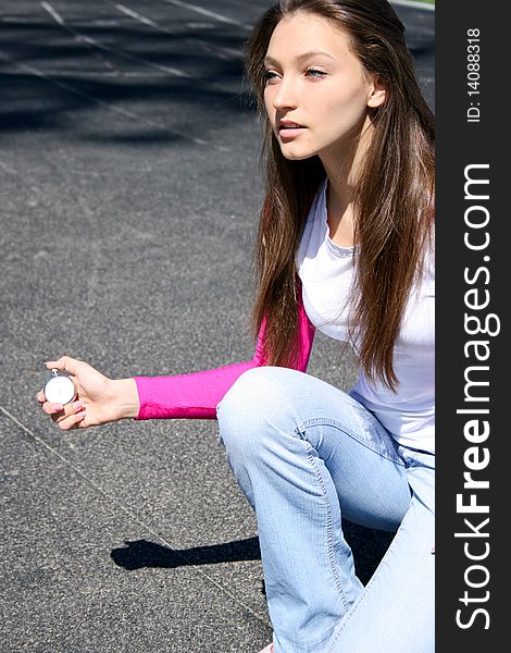 Teen girl at the sports competition with stopwatch
