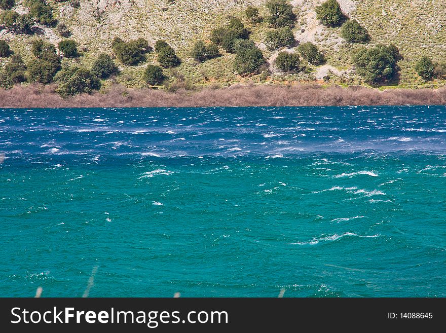 Blue lake in a very windy spring day.