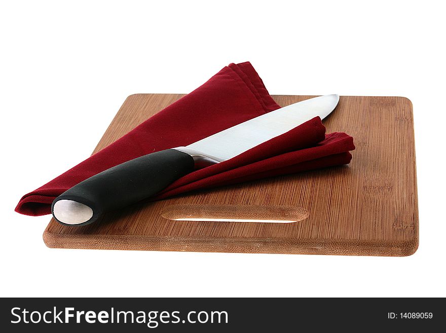 Professional big cook knife on darkly red napkin and a kitchen board.