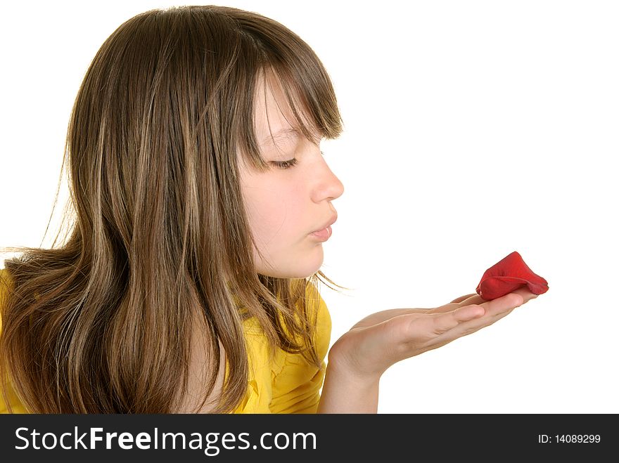 Girl blows on flower petal isolated in white