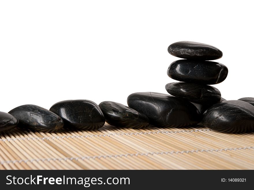 Some stones lie on mat isolated in white