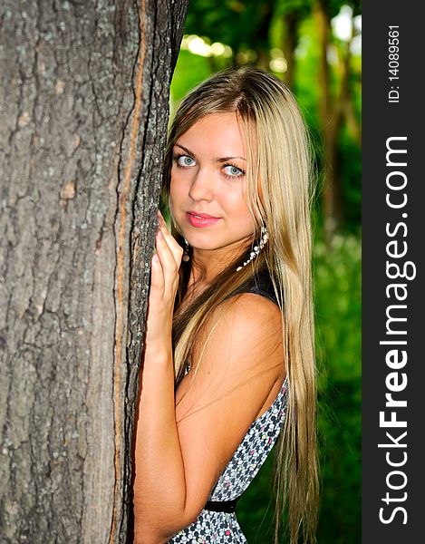 Portrait of pretty young woman near the tree. Portrait of pretty young woman near the tree