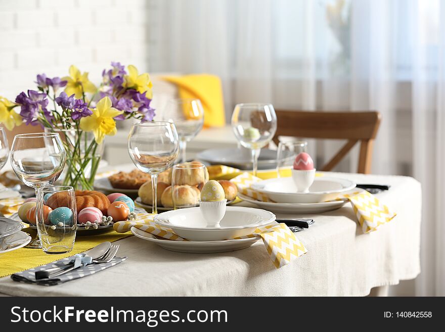 Festive Easter table setting with traditional meal at home, space for text