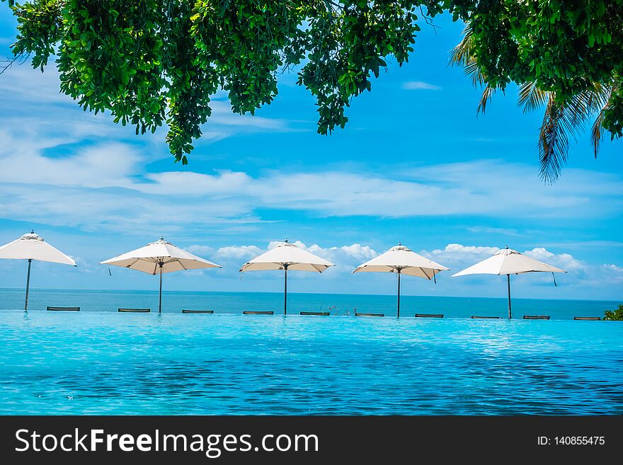 Beautiful Luxury Umbrella And Chair Around Swimming Pool In Hotel And Resort