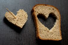 Hearts Carved From A Piece Of Bread On A Wooden Table Stock Image