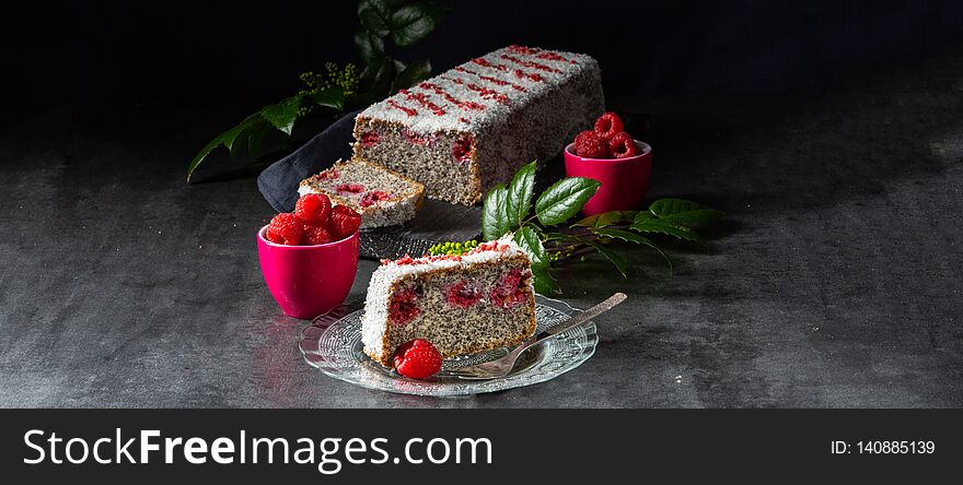 A poppy seed cake with raspberries and grated coconut