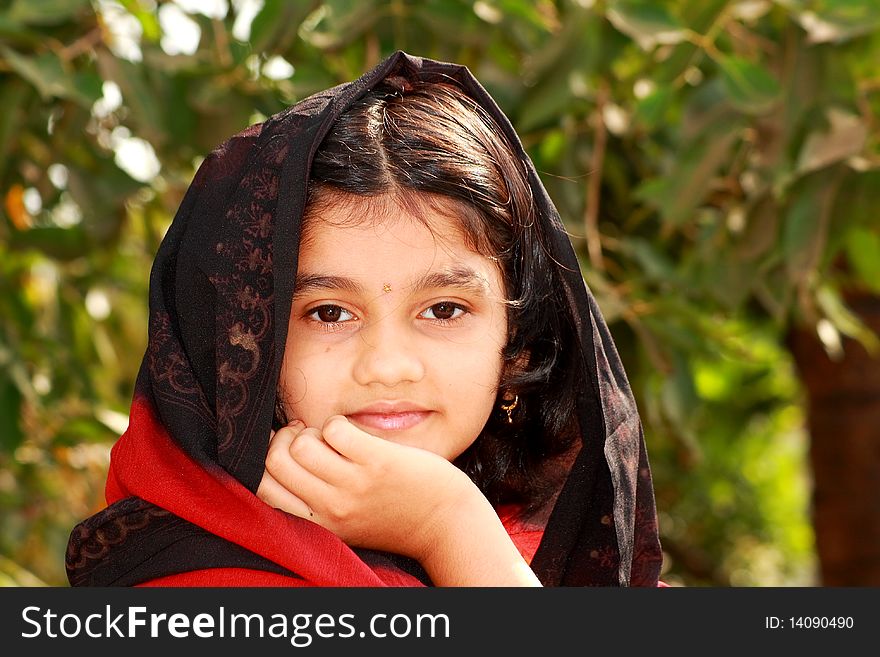 A small Indian girl with her nice and beautiful face and warm thoughts. A small Indian girl with her nice and beautiful face and warm thoughts.