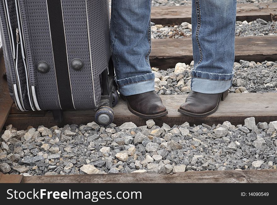 Bag at his feet, road shoes and suitcase, funny picture. Bag at his feet, road shoes and suitcase, funny picture