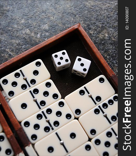 Closeup of a dominoes laying on a flat surface.
