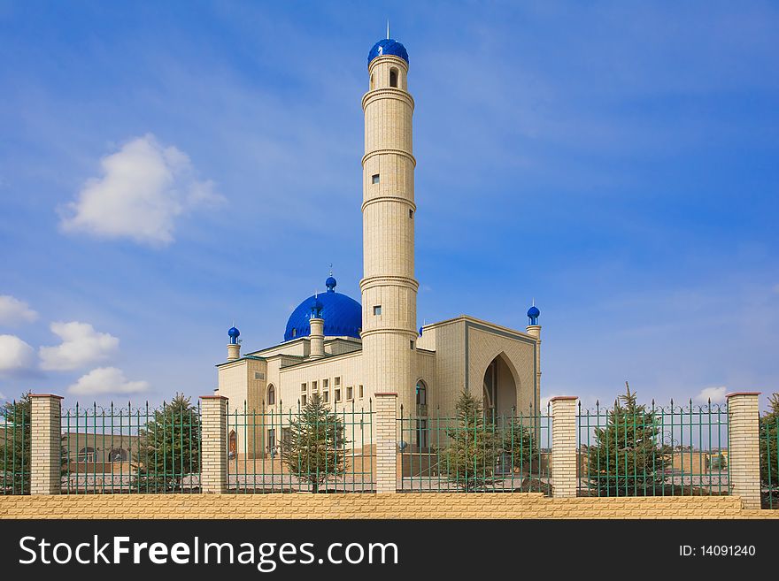 Kazakh muslim orthodox Islamic mosque. A moon on a dome on a blue sky.