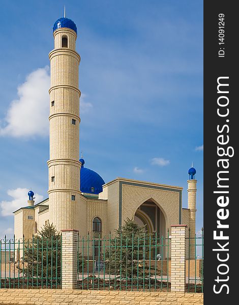 Kazakh muslim orthodox Islamic mosque. A moon on a dome on a blue sky.