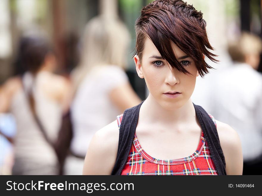 Young modern looking girl over urban background. Young modern looking girl over urban background