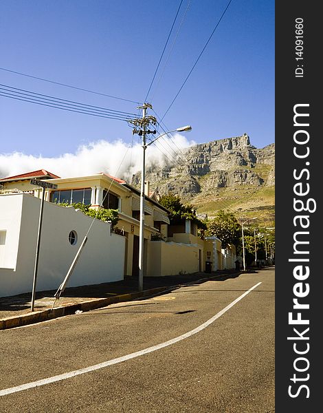 A street scene in Cape Town, South Africa, with table mountain in the background.