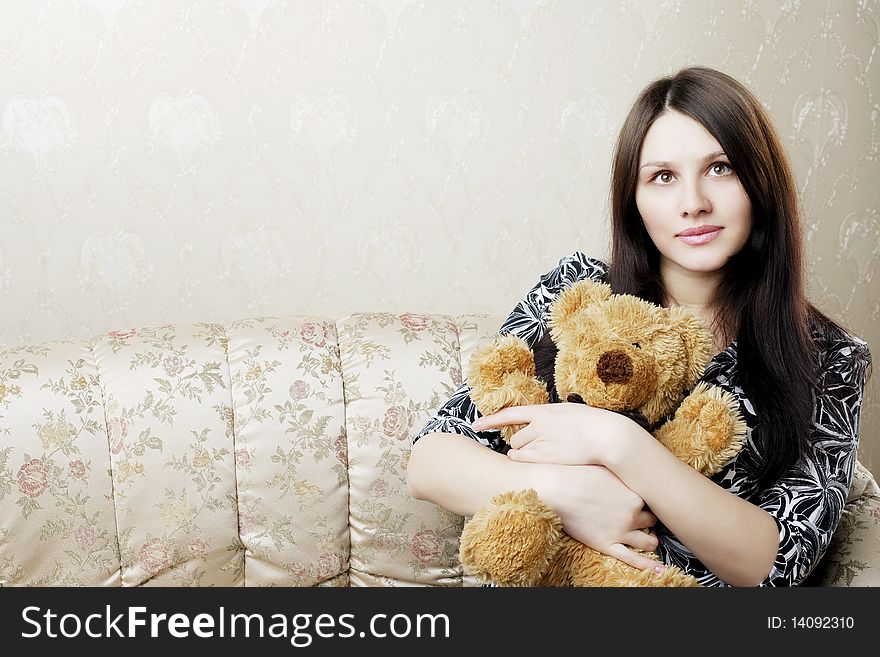 Pregnant woman sitting on a vintage couch