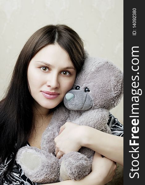 The image of a beautiful pregnant woman sitting on a vintage couch