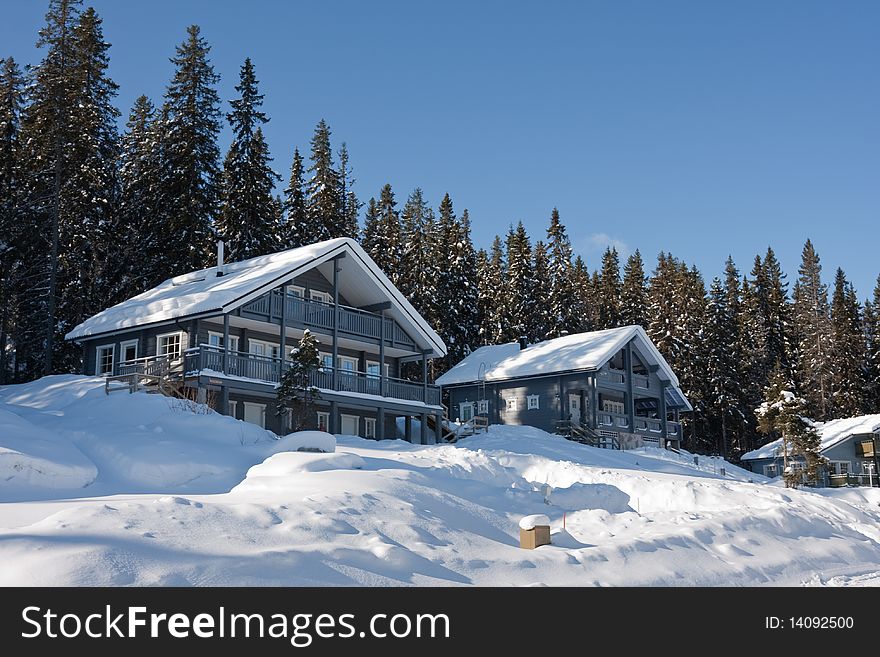 Cottages in winter forest. Finland.