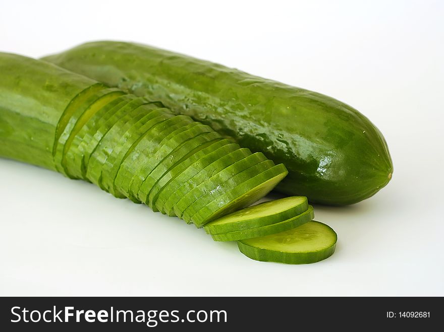 Two green cucumbers on the white background