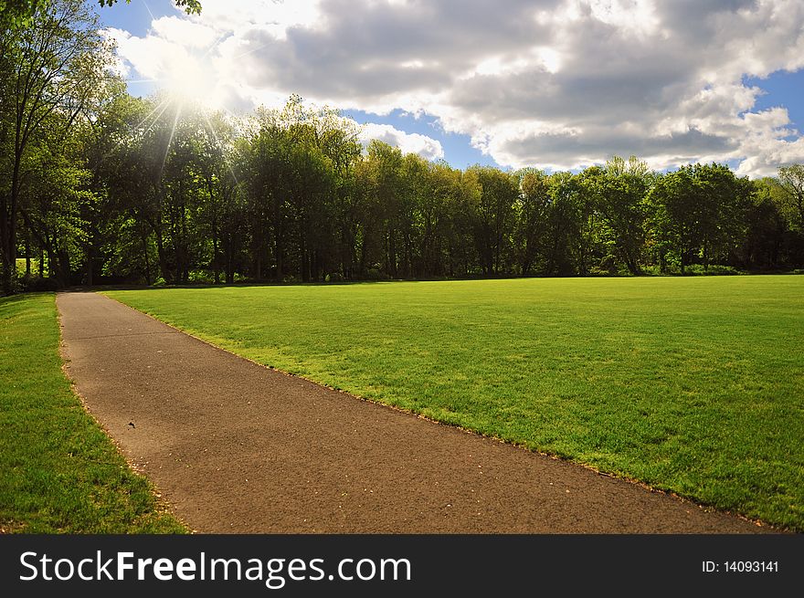 A lush green park on a bright sunny day. A lush green park on a bright sunny day