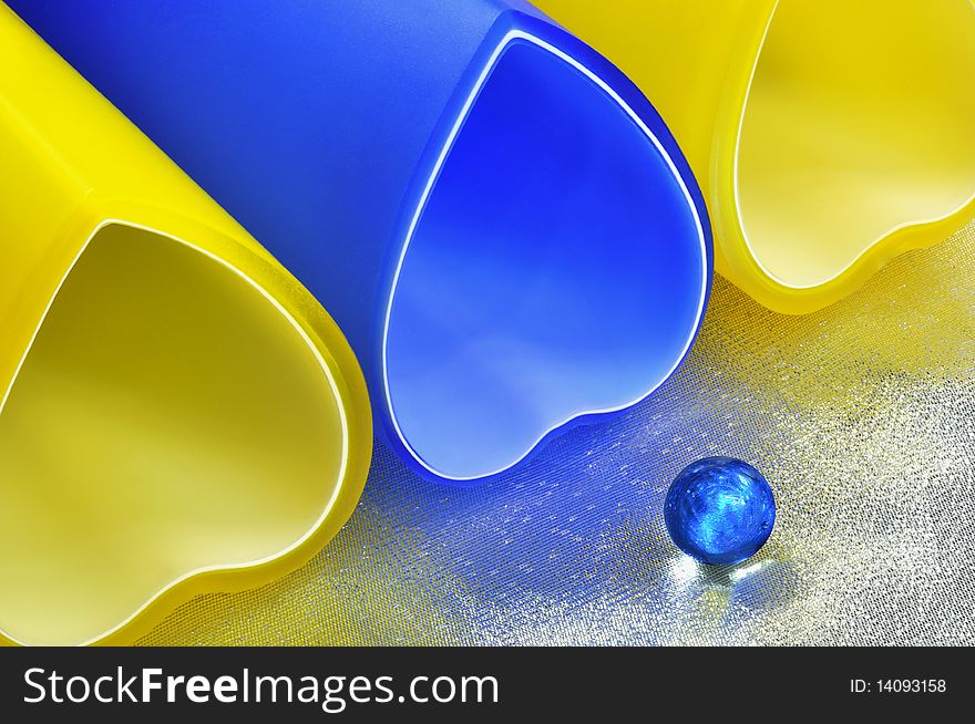 Colour glass bowls are on silver cloth. Colour glass bowls are on silver cloth