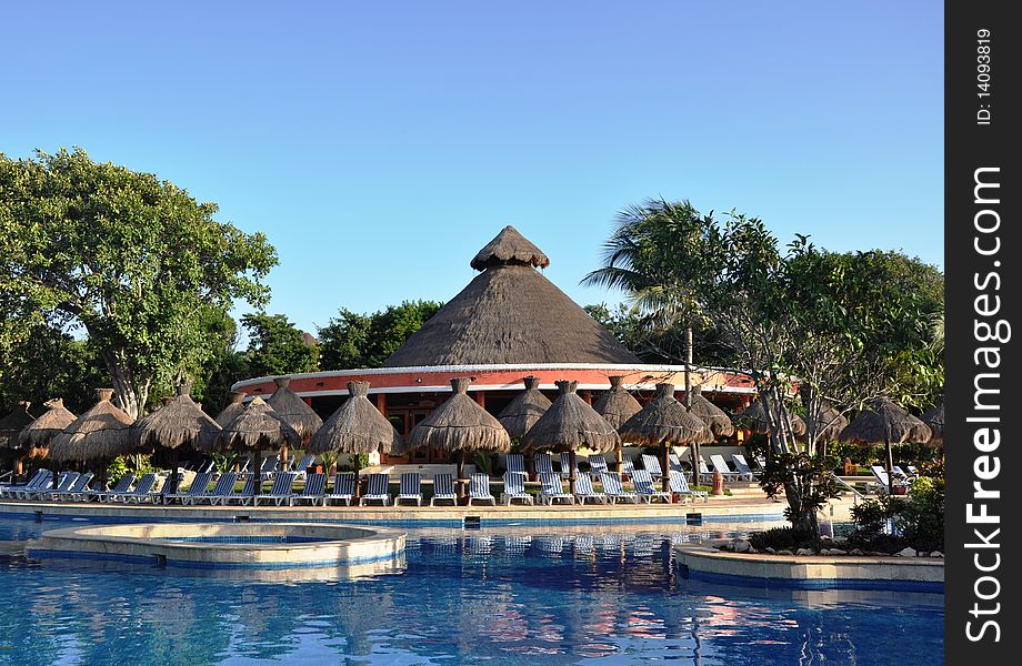 Morning. Resort swimming pool, palm trees in beams dawn sun. Morning. Resort swimming pool, palm trees in beams dawn sun.