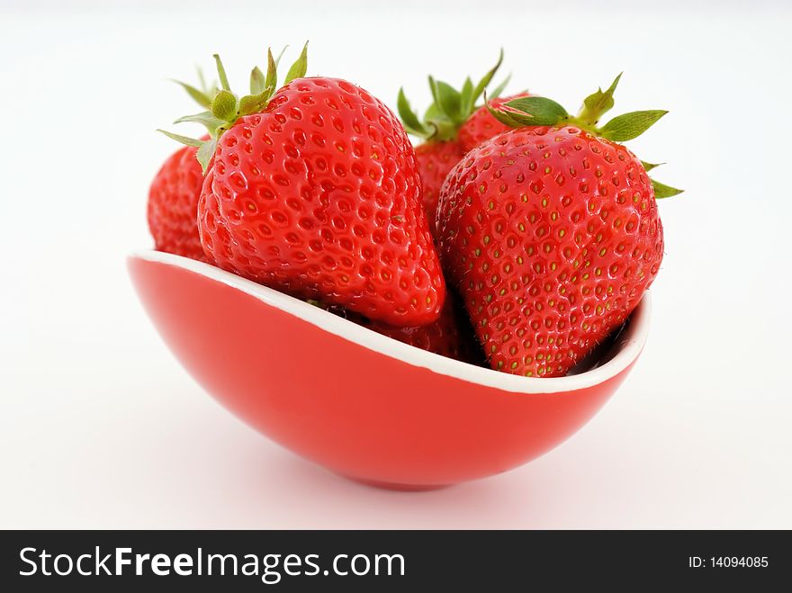 A saucer with strawberries isolated on white background. A saucer with strawberries isolated on white background