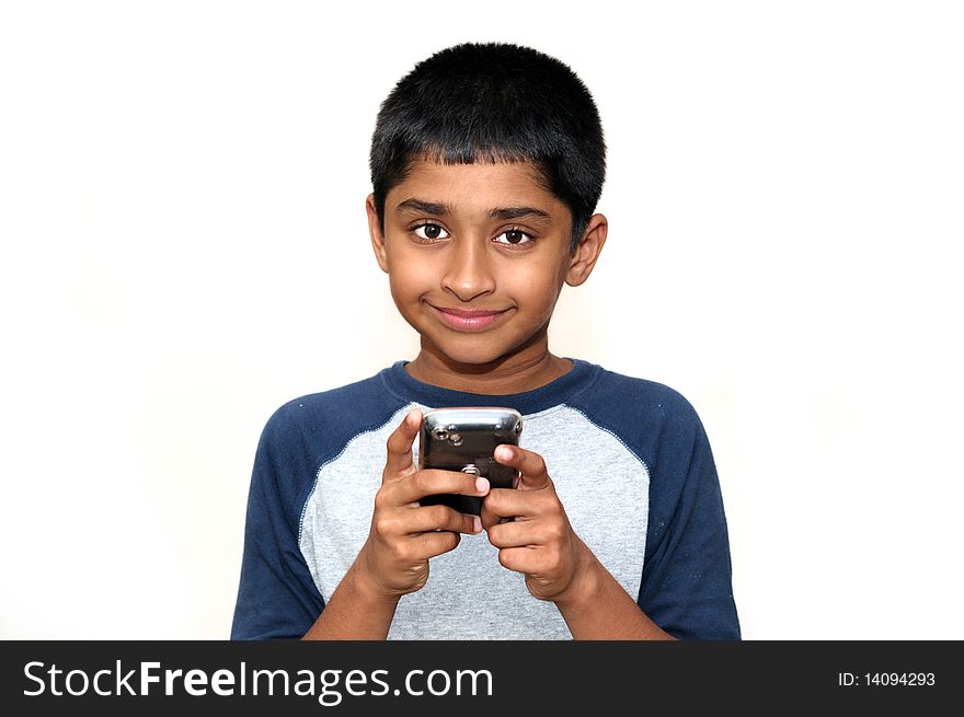 An handsome Indian kid playing games with teh cell phone