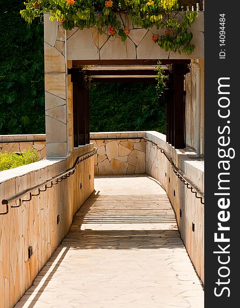 A Portrait of Garden Downhill Walkway with Hanging Plants and Flowers