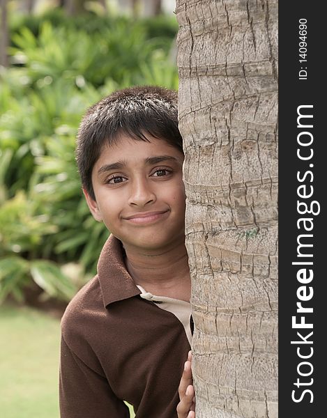 An handsome Indian kid peeping thru the trunk