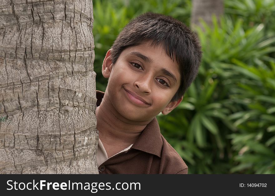 An handsome Indian kid peeping thru the trunk