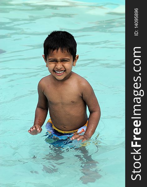 An handsome Indian kid ready to swim by the pool. An handsome Indian kid ready to swim by the pool