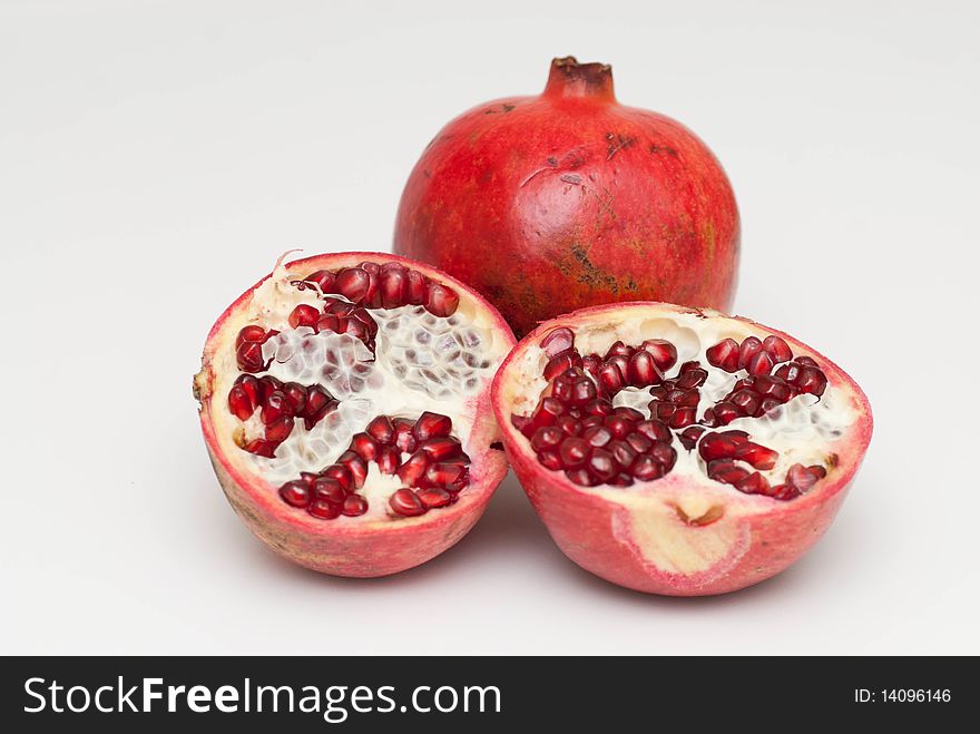 Fresh cut pomegranate on a white background. Fresh cut pomegranate on a white background