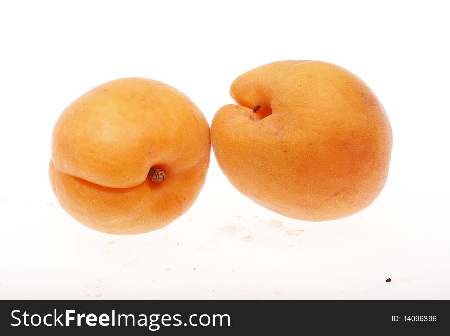 Two fresh apricots isolated on white background