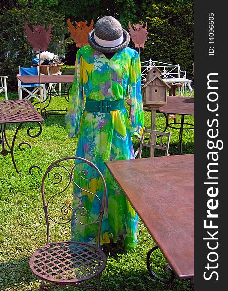 Colorful vintage female dress, exhibited in the garden