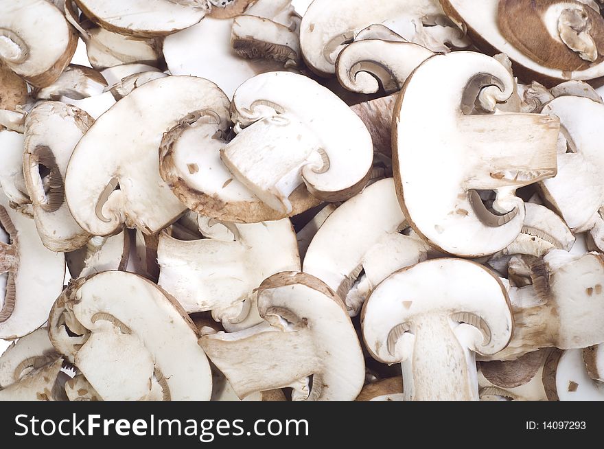 Sliced brown mushrooms on a white background. Sliced brown mushrooms on a white background