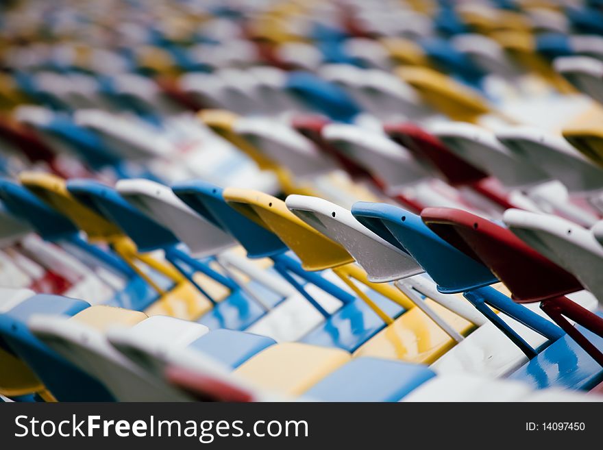 Colorful stadium seats with a shallow depth of field from a motorsports facility.