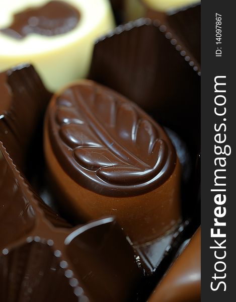 Delicious background of swiss dark chocolates, milk chocolates, pralines and truffles