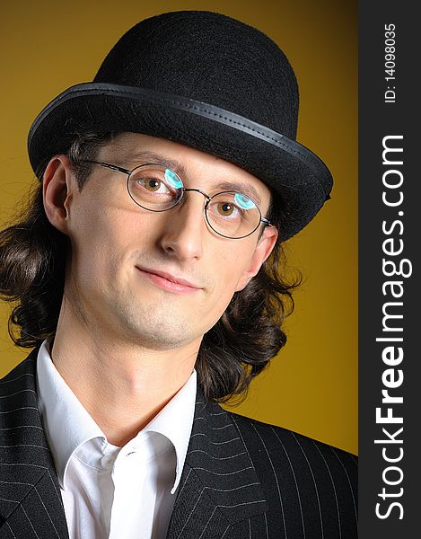 Close up retro portrait of young english gentleman in bowler hat and retro glasses
