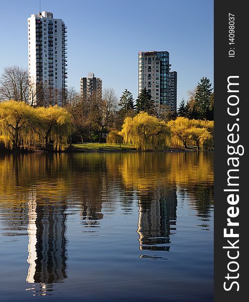 Reflected buildings on the calm water in the morning at Lost Lagoon in Stanley Park, Vancouver. Reflected buildings on the calm water in the morning at Lost Lagoon in Stanley Park, Vancouver.