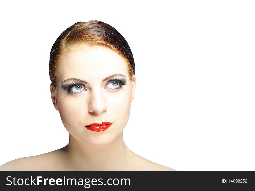 Young beauty female face with red shiny lips and black eye makeup. colse-up.