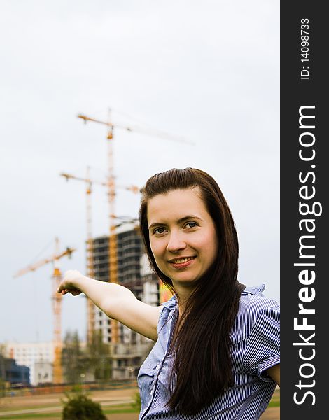 Girl on the background of a building under construction