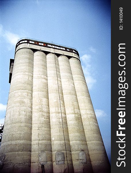 Impressively tall cereal storage silo, perspective view with vignette. Film scan. Impressively tall cereal storage silo, perspective view with vignette. Film scan.