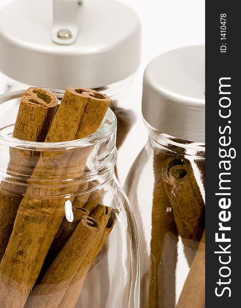 Cinnamon sticks in glass pots, studio shot, close up