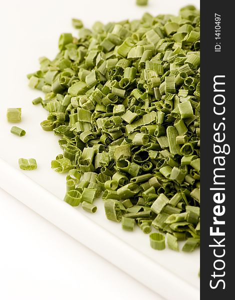 Freeze dried chives on a plate against a white background, Studio shot.